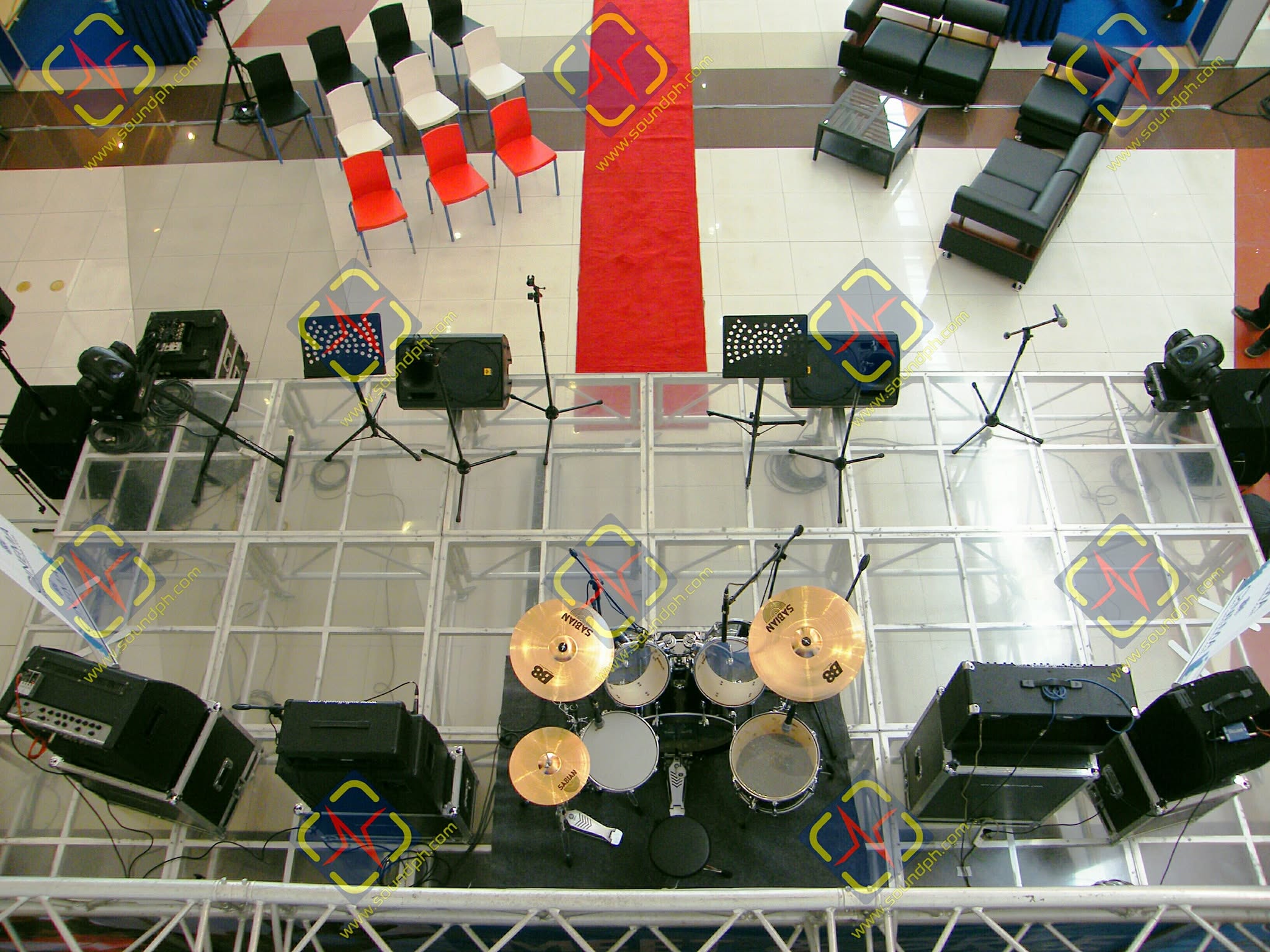 Soundph elevated stage with drum kit, microphones, speakers and lighting equipment